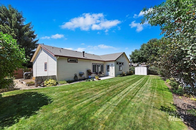 2668 N Morello, Meridian, ID 83646 - back of property with an outbuilding, a lawn, a storage unit, a patio area, and fence