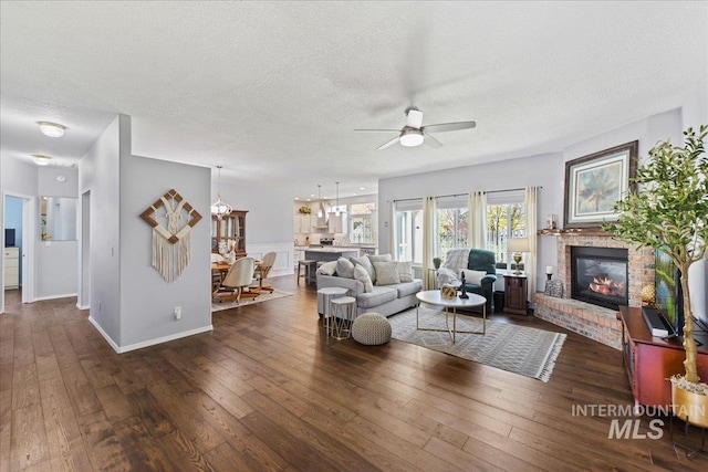 2668 N Morello, Meridian, ID 83646 - living area with baseboards, a ceiling fan, a textured ceiling, a fireplace, and wood-type flooring