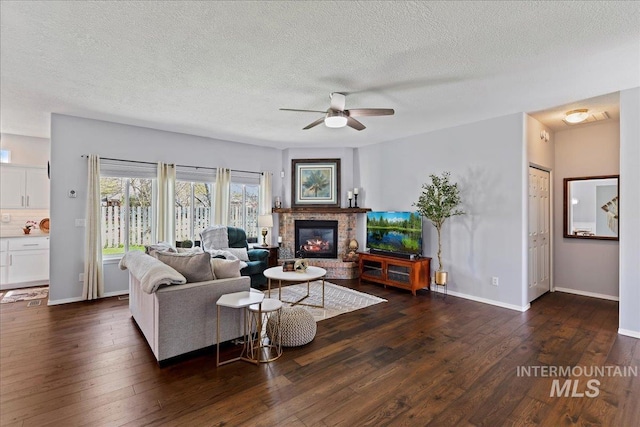 2668 N Morello, Meridian, ID 83646 - living area featuring ceiling fan, a fireplace, a textured ceiling, dark wood-style flooring, and baseboards
