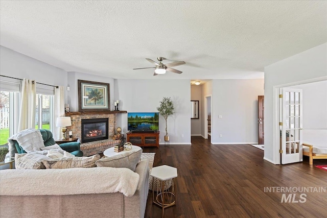 2668 N Morello, Meridian, ID 83646 - living area featuring dark wood-style flooring, ceiling fan, a textured ceiling, and a fireplace