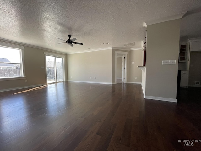 spare room featuring ceiling fan, ornamental molding, dark wood finished floors, and baseboards