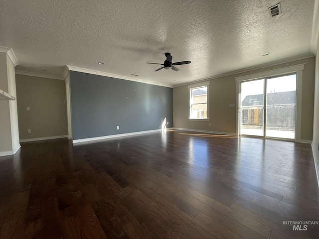 spare room with ornamental molding, dark wood-style flooring, and visible vents