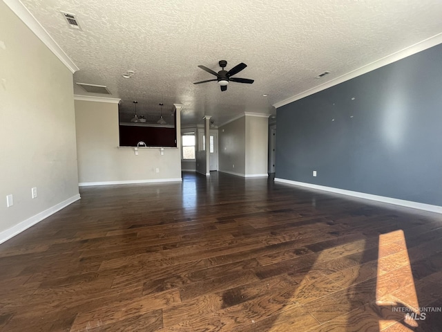 unfurnished living room featuring ornamental molding, visible vents, ceiling fan, and wood finished floors