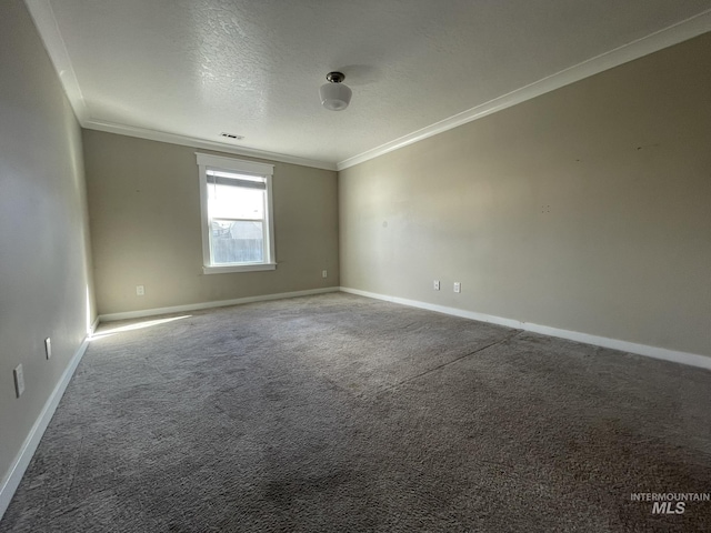 carpeted empty room featuring ornamental molding, visible vents, a textured ceiling, and baseboards