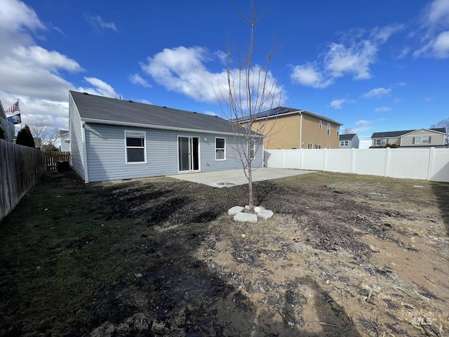 back of property with a patio and a fenced backyard