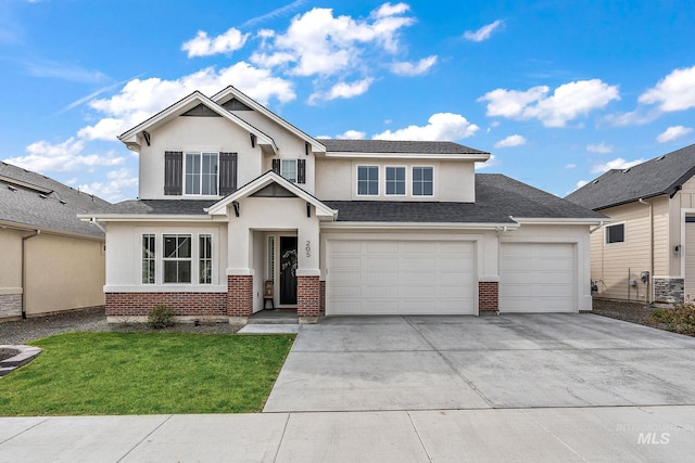 205 S Sunniva Ave, Kuna, ID 83634 - view of front of house with brick siding, driveway, stucco siding, and a front lawn