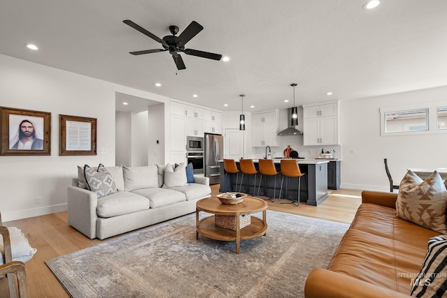 205 S Sunniva Ave, Kuna, ID 83634 - living area featuring a ceiling fan, baseboards, light wood-style floors, and recessed lighting