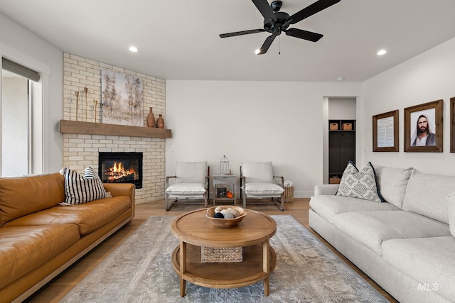 205 S Sunniva Ave, Kuna, ID 83634 - living area with ceiling fan, a fireplace, wood finished floors, and recessed lighting
