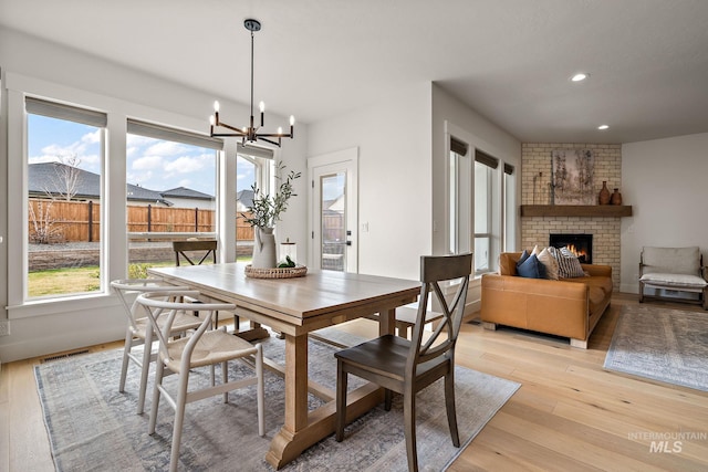 205 S Sunniva Ave, Kuna, ID 83634 - dining room with plenty of natural light, a fireplace, light wood-style flooring, and recessed lighting