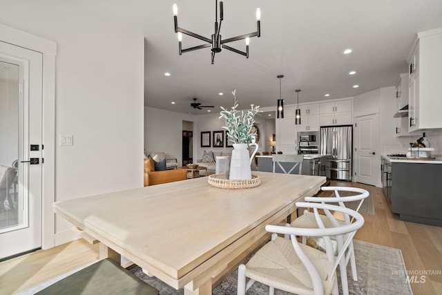 205 S Sunniva Ave, Kuna, ID 83634 - dining area with recessed lighting, light wood-type flooring, a chandelier, and a ceiling fan