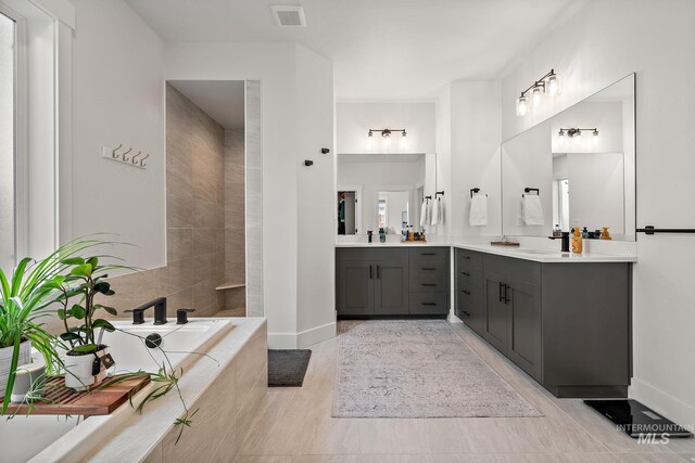 205 S Sunniva Ave, Kuna, ID 83634 - full bath with vanity, a garden tub, and baseboards