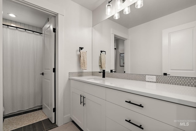 205 S Sunniva Ave, Kuna, ID 83634 - bathroom featuring double vanity, backsplash, tile patterned floors, and curtained shower