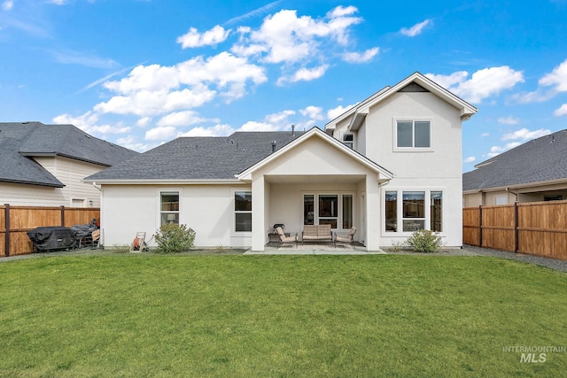 205 S Sunniva Ave, Kuna, ID 83634 - back of property with stucco siding, a patio area, and a shingled roof
