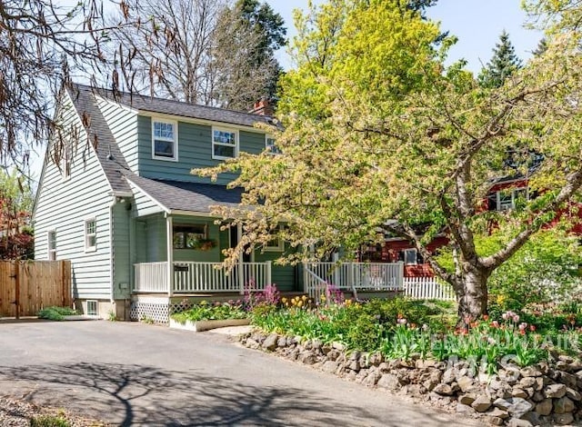 517 E C St, Moscow, ID 83843 - view of front of house with a porch, a shingled roof, fence, and asphalt driveway