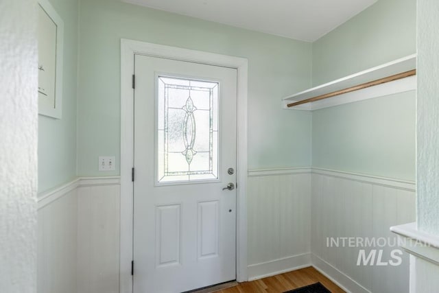 517 E C St, Moscow, ID 83843 - doorway with a wainscoted wall and light wood-style floors