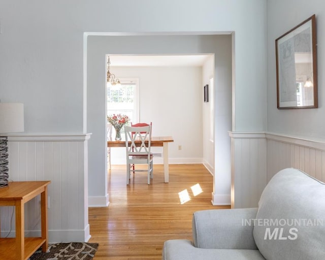 517 E C St, Moscow, ID 83843 - hallway with light wood-style flooring, wainscoting, and a chandelier