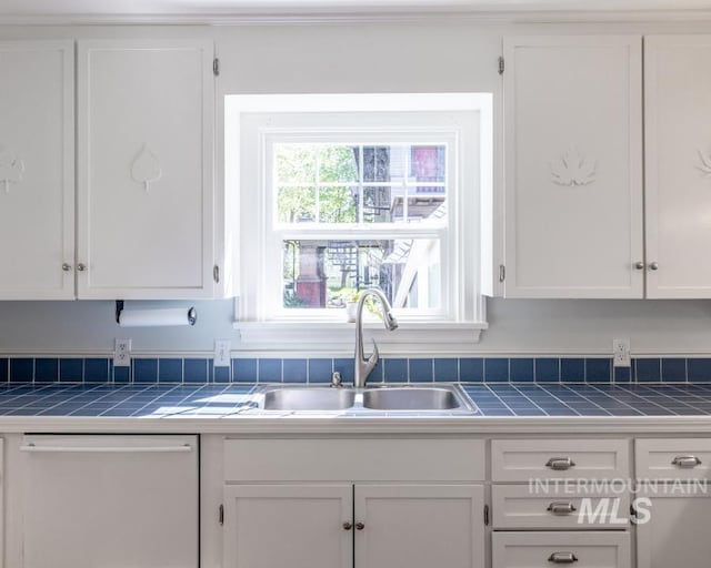 517 E C St, Moscow, ID 83843 - kitchen featuring a sink, tile countertops, dishwasher, and white cabinetry
