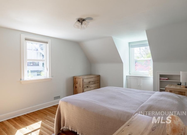517 E C St, Moscow, ID 83843 - bedroom featuring wood finished floors, baseboards, and vaulted ceiling
