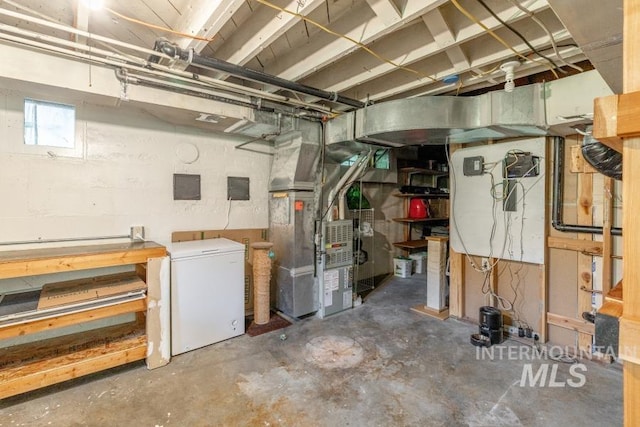 517 E C St, Moscow, ID 83843 - basement featuring refrigerator, heating unit, and electric panel
