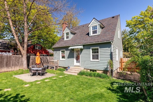 517 E C St, Moscow, ID 83843 - cape cod house with a chimney, a patio area, and a shingled roof