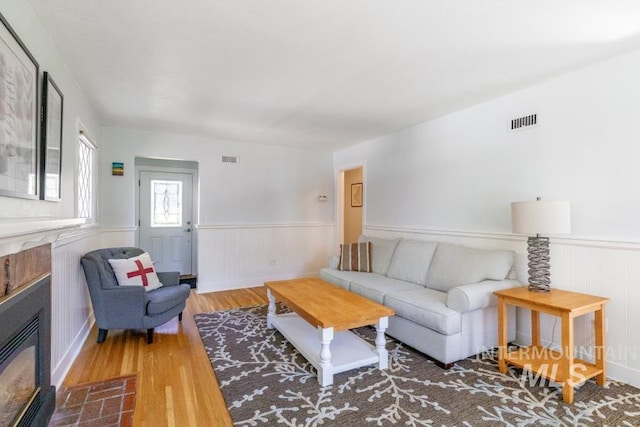 517 E C St, Moscow, ID 83843 - living room with wainscoting, wood finished floors, and a fireplace