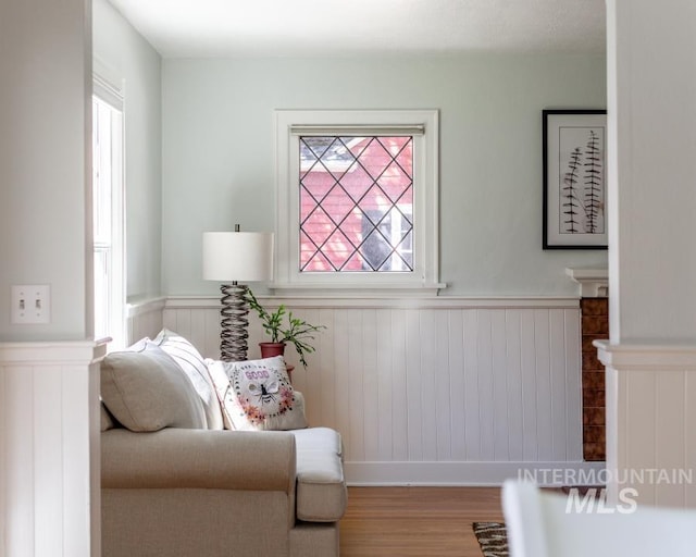 517 E C St, Moscow, ID 83843 - sitting room featuring a wainscoted wall, healthy amount of natural light, and wood finished floors