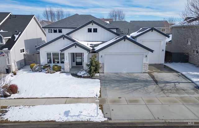 view of front facade with a garage, driveway, central AC unit, a residential view, and fence