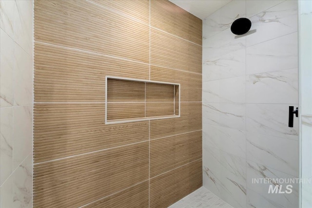 bathroom with tiled shower