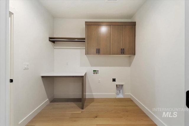 washroom featuring electric dryer hookup, cabinets, hookup for a washing machine, and light hardwood / wood-style flooring