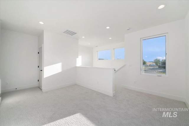 empty room with light colored carpet