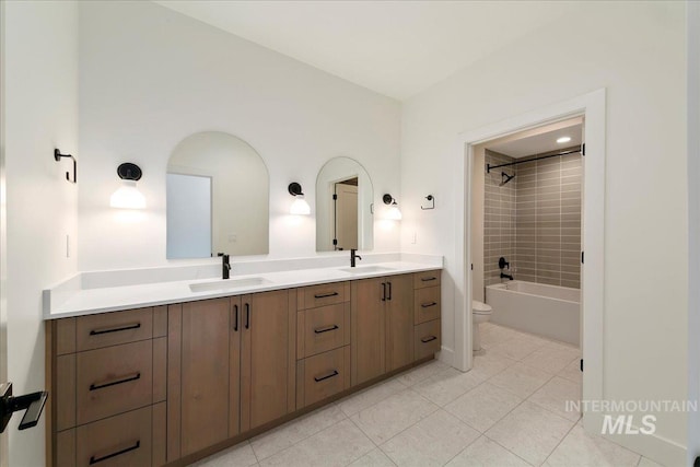 full bathroom featuring vanity, toilet, and tiled shower / bath combo