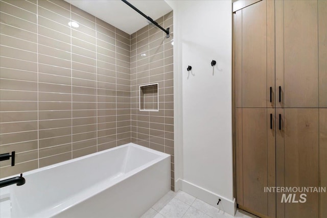 bathroom with tile patterned flooring and shower / washtub combination