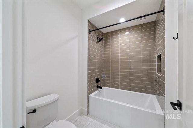 bathroom with tile patterned flooring, toilet, and tiled shower / bath