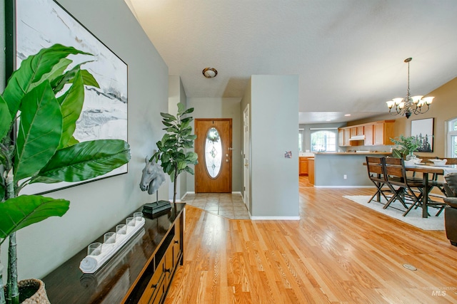 entrance foyer featuring a chandelier and light hardwood / wood-style floors