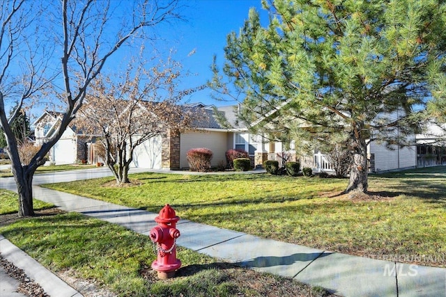 view of front of home with a garage and a front yard