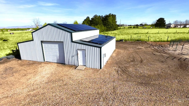 1295 S Dawcamry Ln, Kuna, ID 83634 - detached garage with solar panels, a view of rural / pastoral area, and driveway