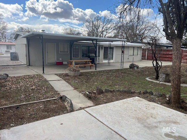 view of front of house featuring a patio and fence