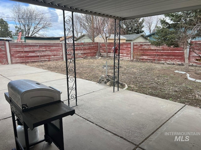 view of patio with grilling area and a fenced backyard