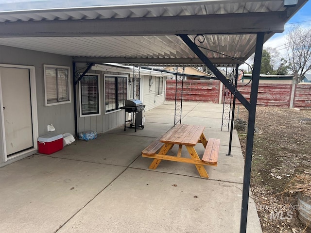 view of patio / terrace featuring fence and a grill