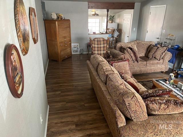 living area featuring baseboards and wood finished floors