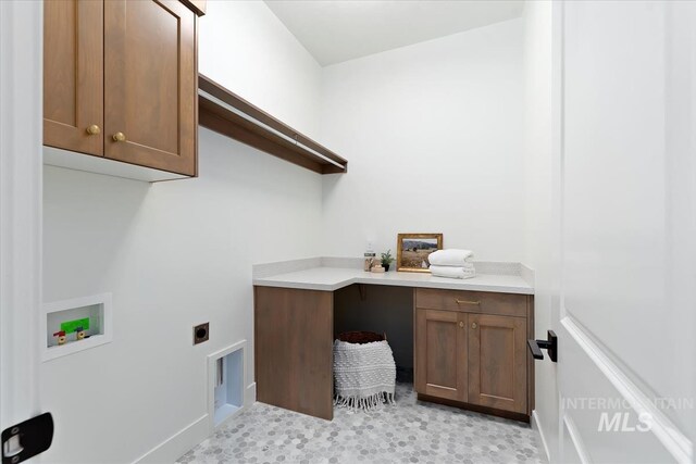laundry room with baseboards, washer hookup, hookup for an electric dryer, and cabinet space