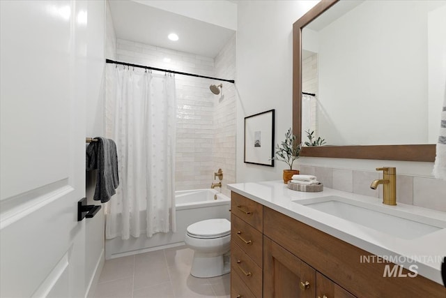 full bathroom featuring vanity, tile patterned flooring, toilet, and shower / tub combo with curtain