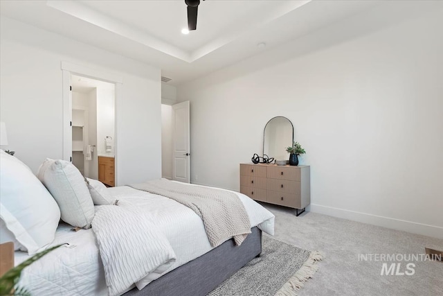 bedroom with light carpet and connected bathroom