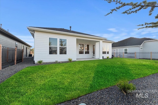 rear view of property with a lawn