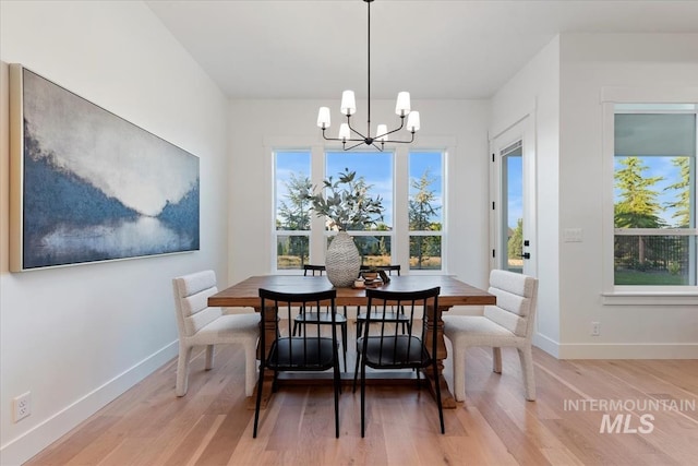 dining space with a chandelier, light hardwood / wood-style floors, and a healthy amount of sunlight