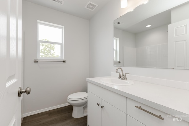 5754 W Stavros St, Meridian, ID 83646 - bathroom with vanity, toilet, wood finished floors, and baseboards