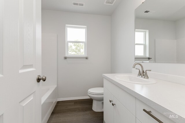 5754 W Stavros St, Meridian, ID 83646 - full bath with toilet, vanity, wood finished floors, and baseboards