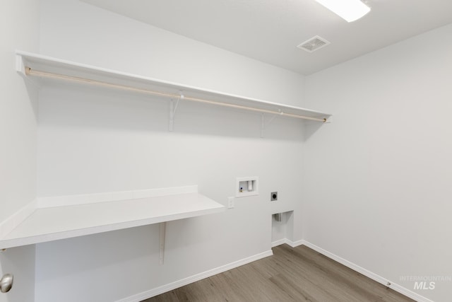 5754 W Stavros St, Meridian, ID 83646 - laundry room featuring hookup for an electric dryer, wood finished floors, hookup for a washing machine, and baseboards