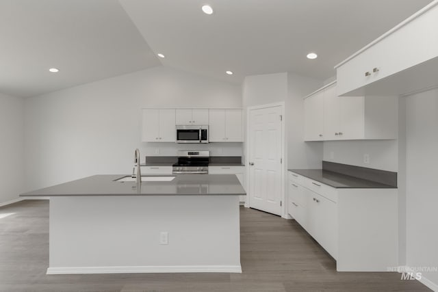 5754 W Stavros St, Meridian, ID 83646 - kitchen with appliances with stainless steel finishes, a sink, white cabinetry, wood finished floors, and recessed lighting