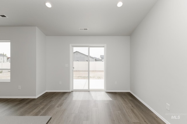 5754 W Stavros St, Meridian, ID 83646 - spare room with wood finished floors, baseboards, and recessed lighting